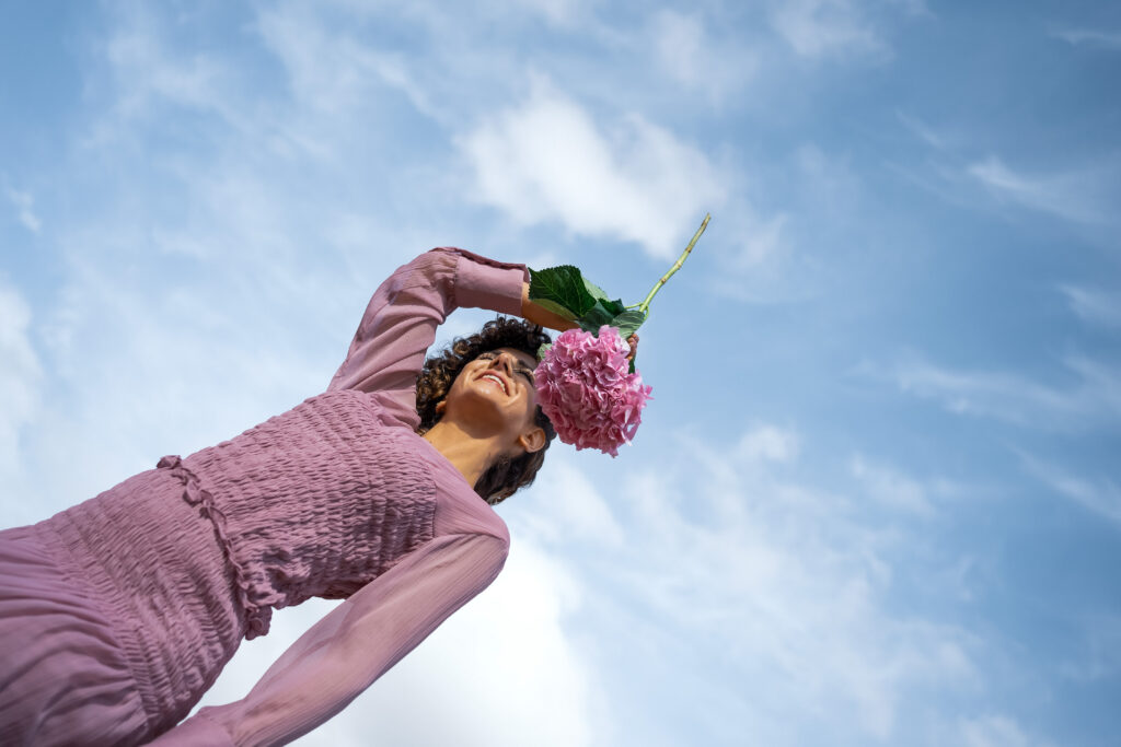 ragazza che tiene il fiore di un ortensia in mano